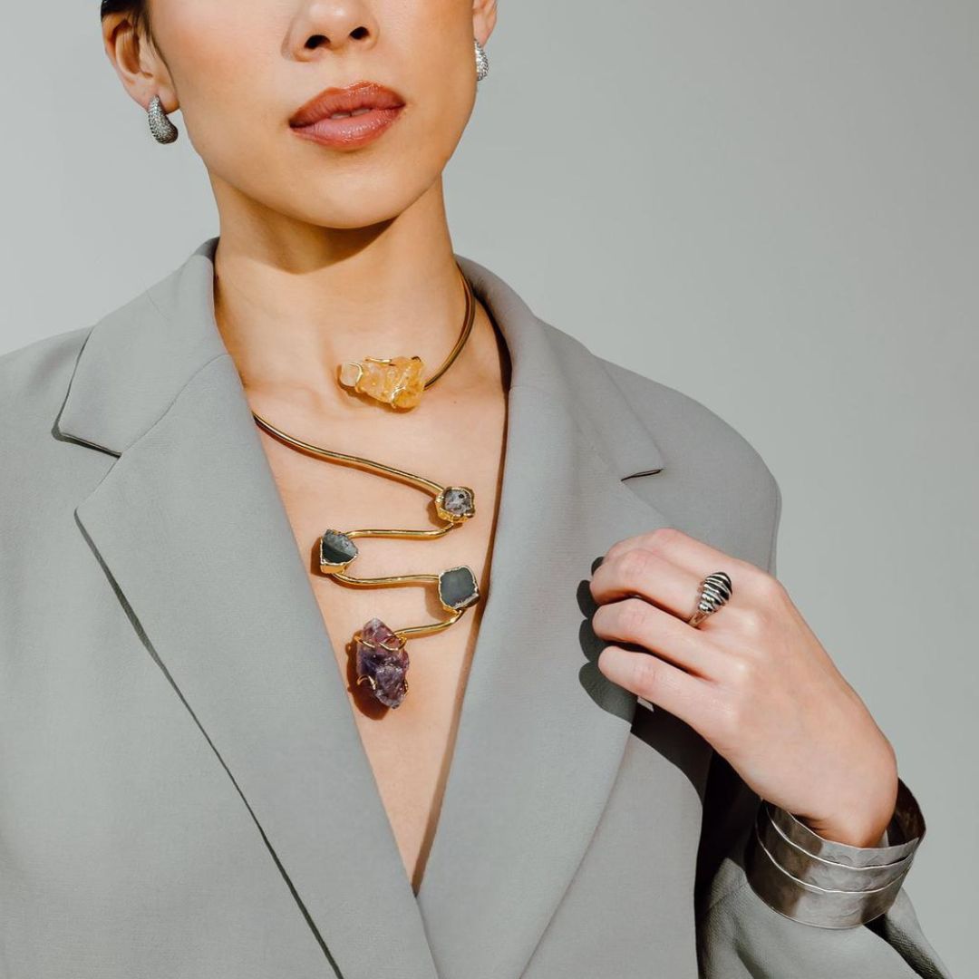 Close up of a model wearing the Siena handmade gold plated choker necklace with raw gemstone pendants